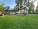 Spacious backyard featuring lush green lawn and a charming patio perfect for outdoor gatherings at 661 Oak Dr, Riverdale, GA 30274