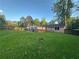 A view of the backyard displaying the home's exterior, complemented by a spacious lawn at 661 Oak Dr, Riverdale, GA 30274
