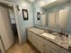Well-lit bathroom features granite countertops, white cabinetry, and modern fixtures at 661 Oak Dr, Riverdale, GA 30274