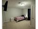 Spacious bedroom offering a view of a wall-mounted TV, with ample room for relaxation and recreation at 661 Oak Dr, Riverdale, GA 30274