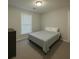 Neutral bedroom featuring carpet, a window with blinds, and comfortable sleeping arrangements at 661 Oak Dr, Riverdale, GA 30274