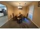 Cozy dining room with a classic chandelier and ample natural light at 661 Oak Dr, Riverdale, GA 30274