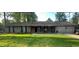 Traditional brick home with a well-manicured lawn and mature trees at 661 Oak Dr, Riverdale, GA 30274