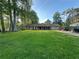 Charming home with a brick facade, large front lawn, and convenient driveway parking at 661 Oak Dr, Riverdale, GA 30274