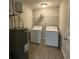 Functional laundry room equipped with a washer, dryer, and storage shelves at 661 Oak Dr, Riverdale, GA 30274