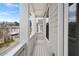 Outdoor balcony featuring white railings overlooking a charming street at 91 Batten Board Way, Woodstock, GA 30189