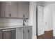 Close up shot of a bar featuring a white countertop, grey cabinets and a tiled backsplash at 91 Batten Board Way, Woodstock, GA 30189