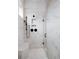 Stunning walk-in shower with sleek black fixtures and marble-style tiling plus built-in bench seating at 91 Batten Board Way, Woodstock, GA 30189