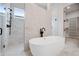 Spa-like bathroom with soaking tub, glass shower, and walk-in closet at 91 Batten Board Way, Woodstock, GA 30189