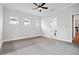 Spacious bedroom with carpeted floor, ceiling fan, and natural lighting at 91 Batten Board Way, Woodstock, GA 30189