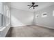 Bright bedroom with carpeted floor, ceiling fan, and natural lighting from large windows at 91 Batten Board Way, Woodstock, GA 30189