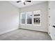 Well-lit bedroom features three windows, ceiling fan and gray carpet at 91 Batten Board Way, Woodstock, GA 30189