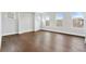 Spacious bedroom featuring hardwood floors and ample natural light from three large windows at 91 Batten Board Way, Woodstock, GA 30189