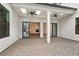A covered outdoor patio with stone pavers and ceiling fans provides a relaxing space at 91 Batten Board Way, Woodstock, GA 30189
