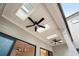 Covered patio with skylights, ceiling fans and view of hardwood floors through sliding glass doors at 91 Batten Board Way, Woodstock, GA 30189