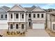 Beautiful two-story home featuring stone accents, a two-car garage, and a charming second-story balcony at 91 Batten Board Way, Woodstock, GA 30189