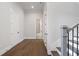Upstairs hallway featuring hardwood floors, neutral walls, and doors leading to various rooms at 91 Batten Board Way, Woodstock, GA 30189