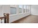 Hallway featuring wood floors, neutral walls, and several windows at 91 Batten Board Way, Woodstock, GA 30189
