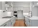 Kitchen with gray cabinetry, stainless steel appliances, and island sink at 91 Batten Board Way, Woodstock, GA 30189
