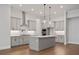 Kitchen with gray cabinetry, quartz countertops, stainless steel appliances and center island at 91 Batten Board Way, Woodstock, GA 30189