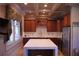 Stylish kitchen with white marble countertops, a coffered ceiling, stainless steel appliances, and wood cabinets at 91 Batten Board Way, Woodstock, GA 30189