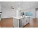 Open floor plan showcasing kitchen island with stainless steel appliances and hardwood floors at 91 Batten Board Way, Woodstock, GA 30189
