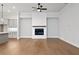 Living room with hardwood floors, fireplace with white shiplap and modern ceiling fan at 91 Batten Board Way, Woodstock, GA 30189