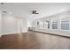 Open-concept living area with hardwood floors, ceiling fan, lots of natural light, and neutral color palette at 91 Batten Board Way, Woodstock, GA 30189