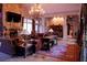 Luxurious living room with stone fireplace, chandelier, rich textures, and a seamless flow at 91 Batten Board Way, Woodstock, GA 30189