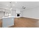 Open floorplan shows kitchen island and fireplace in a large living space at 91 Batten Board Way, Woodstock, GA 30189