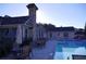 Exterior view of community pool with chairs and lounge area by the building at 91 Batten Board Way, Woodstock, GA 30189