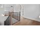 A wooden staircase with black wrought iron spindles leads to the upper level of the home at 91 Batten Board Way, Woodstock, GA 30189