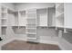 Organized walk-in closet with white shelving and multiple hanging racks to maximize storage and organization at 91 Batten Board Way, Woodstock, GA 30189