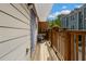 A wooden balcony is furnished with a small table and chairs, with potted plants along the railing at 1365 Memorial Se Dr # 12, Atlanta, GA 30317