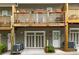 View of the exterior of the townhomes with wood decks and single-car garages at 1365 Memorial Se Dr # 12, Atlanta, GA 30317