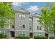 View of modern townhouse with gray siding, white trim, and well-maintained landscaping at 1365 Memorial Se Dr # 12, Atlanta, GA 30317