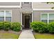 Charming front entrance with dark wood door, manicured shrubs, and a well-lit entryway at 1365 Memorial Se Dr # 12, Atlanta, GA 30317