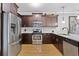 Modern kitchen features stainless steel appliances, granite countertops, and dark wood cabinets at 1365 Memorial Se Dr # 12, Atlanta, GA 30317