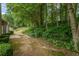 Serene backyard with a private, wooded setting and a small patio at 1909 Riverlanding Cir, Lawrenceville, GA 30046