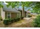 Backyard of home with patio space, mature trees, and fresh landscaping at 1909 Riverlanding Cir, Lawrenceville, GA 30046