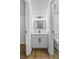 Modern bathroom with white vanity, black hardware, and framed mirror at 1909 Riverlanding Cir, Lawrenceville, GA 30046
