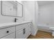 Elegant bathroom featuring modern vanity, quartz countertop, and bathtub with sleek black accents and fixtures at 1909 Riverlanding Cir, Lawrenceville, GA 30046