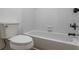 Clean white bathroom with a tub and shower combo and tiled walls at 1909 Riverlanding Cir, Lawrenceville, GA 30046