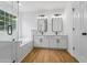 Bathroom featuring double sinks, a glass shower, and a soaking tub at 1909 Riverlanding Cir, Lawrenceville, GA 30046