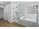 Bathroom featuring a separate glass shower and bathtub with a window at 1909 Riverlanding Cir, Lawrenceville, GA 30046