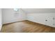 Neutral bedroom featuring hardwood floors and a window for ample natural light at 1909 Riverlanding Cir, Lawrenceville, GA 30046