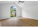 Bedroom with a large window, vaulted ceiling, and wood-look flooring at 1909 Riverlanding Cir, Lawrenceville, GA 30046