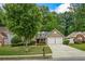 Exterior view of inviting home featuring a well-maintained lawn and a two-car garage at 1909 Riverlanding Cir, Lawrenceville, GA 30046
