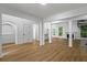 Bright and airy living room with wood floors, white pillars, and a spiral staircase at 1909 Riverlanding Cir, Lawrenceville, GA 30046