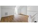 Bright loft space features wood-look floors, a white staircase, and natural light at 1909 Riverlanding Cir, Lawrenceville, GA 30046